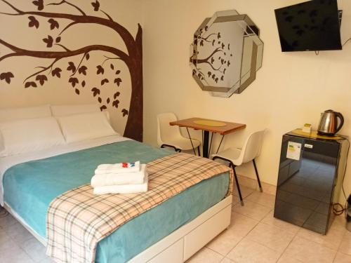 a bedroom with a bed and a table and a television at Hospedaje de Lidia in Lima