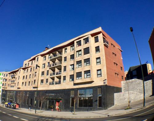 a large brick building on a city street at Bilbao Apartamentos Atxuri in Bilbao
