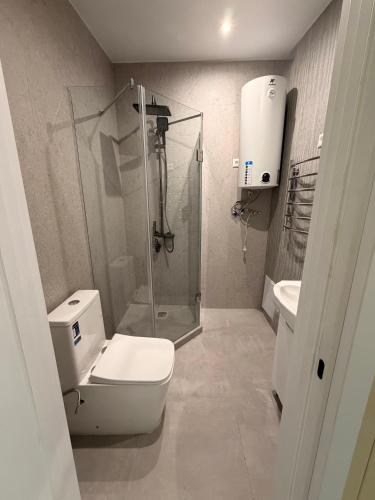 a bathroom with a shower and a toilet and a sink at Panorama Hrytsulivka in Vorokhta