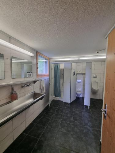 a bathroom with two sinks and two toilets at Tällihütte in Gadmen
