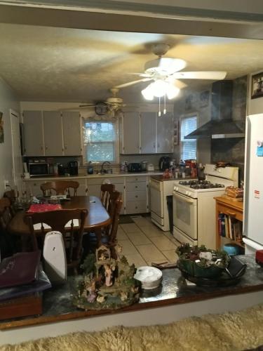 a kitchen with a table and a dining room at Private room in Omaha