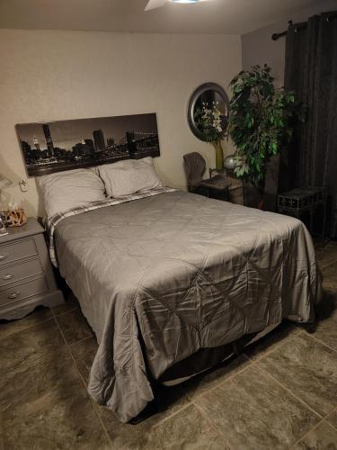 a bedroom with a large bed with a city skyline at El Rinconcito in Santa Ana