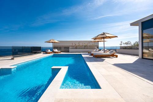 a swimming pool on the roof of a house at Krimovica Villas in Budva