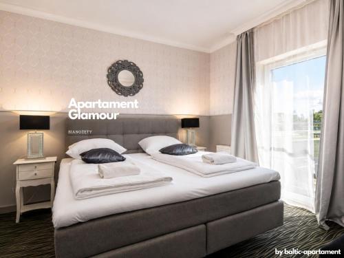 a bedroom with a large bed and a window at Apartament Glamour - 5 Mórz - Basen - SPA - Sauna in Sianozety