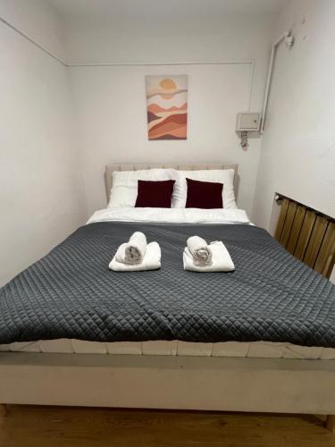 a bedroom with a large bed with towels on it at Apartament przy Agorze in Bytom