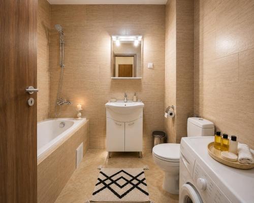 a bathroom with a tub and a toilet and a sink at Ama Residence 1 in Deva