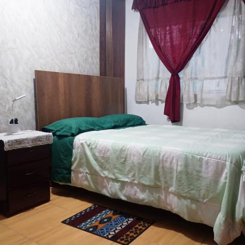 a bedroom with a bed with a canopy and a window at Arequipa- LaPampilla in La Pampilla
