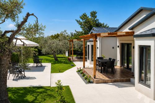 a patio with a black dining table on a wooden deck at Aivazidis Residence I in Skala Kallirachis