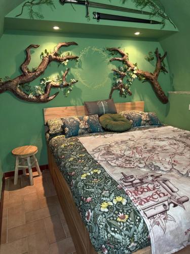 a bedroom with a bed with trees on the wall at Rifugio della Contea - Centro storico Perugia in Perugia