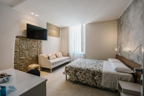 a hotel room with a bed and a couch at Marinucci Rooms in Termoli
