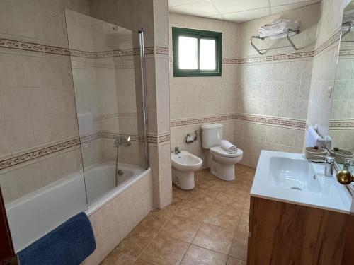a bathroom with a tub and a toilet and a sink at Cap Salou Binda Mar Apartment in Salou