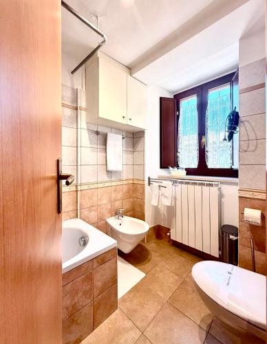 a bathroom with a tub and a toilet and a sink at Via Roma 40 - apartment in Pacentro