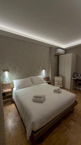 a bedroom with a large bed with two towels on it at L'Alòz in Lugo