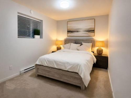 a bedroom with a large bed with two lamps at Cozy South Surrey Private Suite 1 Bedroom - 2 Beds - Separate Entrance in Surrey