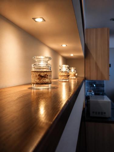 three glass jars sitting on a counter in a kitchen at La Tavernetta in Casto