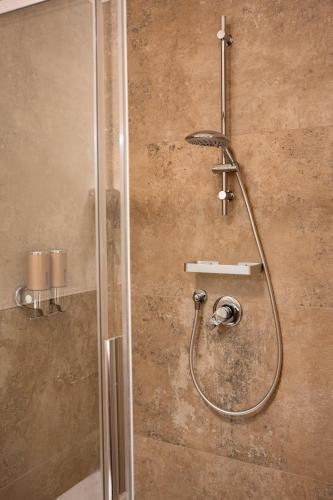 a shower with a glass door in a bathroom at L'Alòz in Lugo