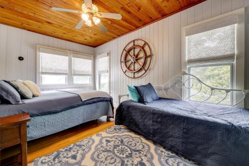 a bedroom with two beds and a ceiling fan at Spacious Lake Placid Retreat w/ Gorgeous Views! in Seguin