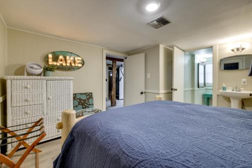 a bedroom with a blue bed and a sink at Spacious Lake Placid Retreat w/ Gorgeous Views! in Seguin