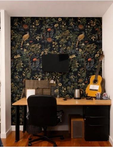 a desk with a monitor and a guitar on a wall at Chambre privé proche gare V électrique in Montauban-de-Bretagne