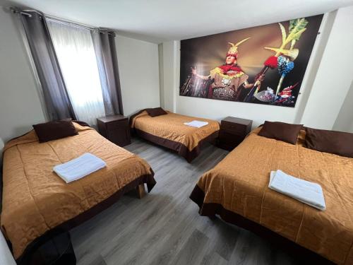 a room with two beds and a painting on the wall at hotel orkkowasi colca in Coporaque