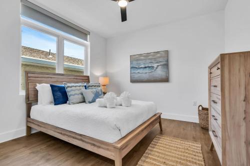 a bedroom with a bed with blue and white pillows at Professionally managed 1 block to beach Coffee in Seaside Heights