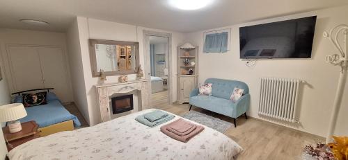 a bedroom with a bed and a fireplace and a tv at Alessandra‘s House in Arezzo