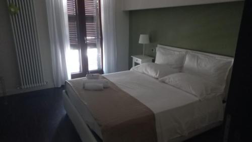 a bedroom with a large white bed with a window at Corso Garibaldi in San Salvo