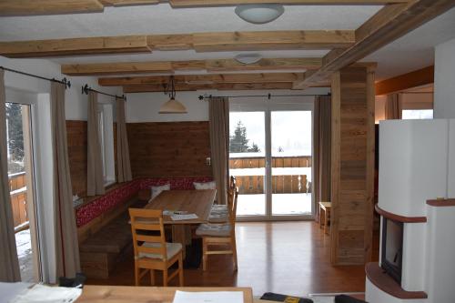 a living room with a table and a couch at Ferienhaus Enterberg in Ramsau im Zillertal