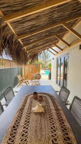 a large wooden table in a room with chairs at Puur Bonaire Boutique Resort in Belnem