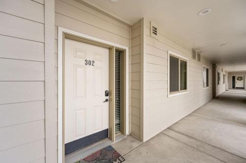 a house with a white door with the number on it at Salmon Run Condo - Overlooking the Spokane River in Post Falls