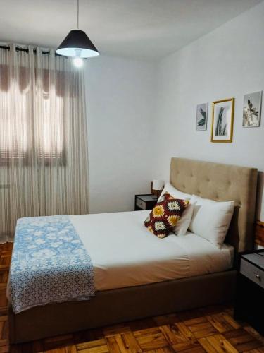 a bedroom with a bed with two pillows on it at Mountain View Guest House,Geres in Geres