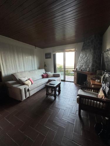 a living room with a couch and a fireplace at Mas Eucaliptus in Susqueda