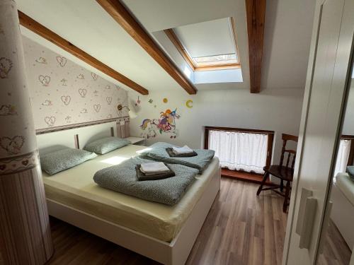 a bedroom with a bed and a skylight at Apartma na podeželju - Slovenia Nature in Kanal