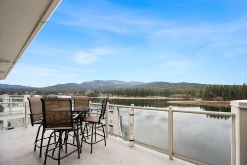 a balcony with a table and chairs and a view of a lake at Riverside Condo - Gorgeous Spokane River View in Post Falls