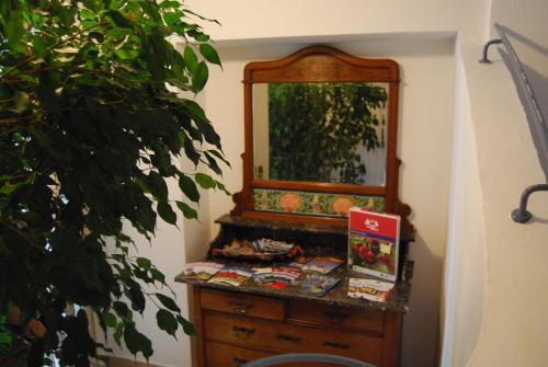 a wooden dresser with a mirror on top of it at Gasthaus zum Löwen - Restaurant Akropolis in Hausach