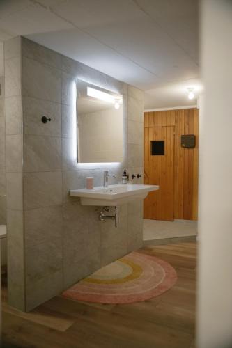 a bathroom with a sink and a mirror at City Lake & Peaks Thun in Thun