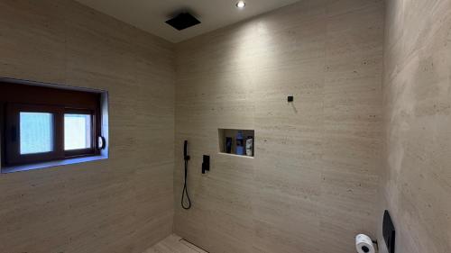 a bathroom with a shower with a window in it at Solemar4 in Vlorë