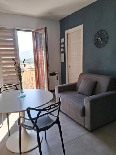 a living room with a couch and a table at Porta San Paolo House in Castelbuono