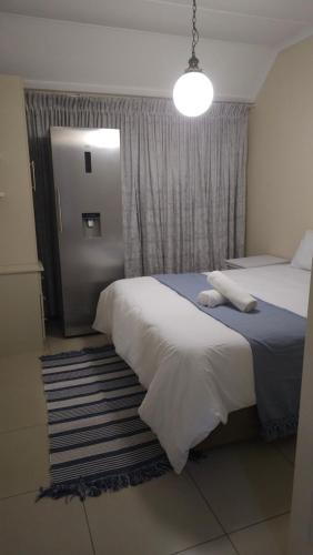 a bedroom with two beds and a large window at 3D Power guest house in Durban