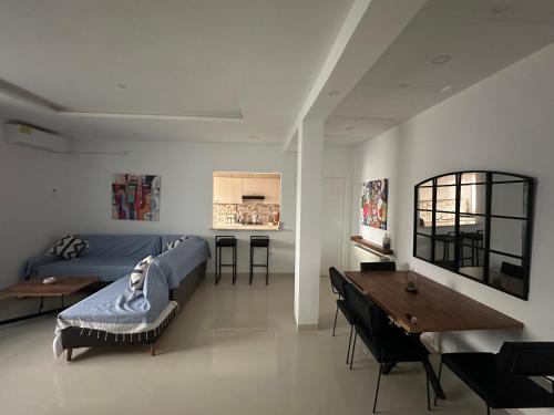 a bedroom with a bed and a desk and a table at Appart Yassou in Dar Salah Bey
