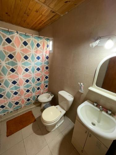 a bathroom with a toilet and a sink and a shower at Departamento norte interno in Rafaela