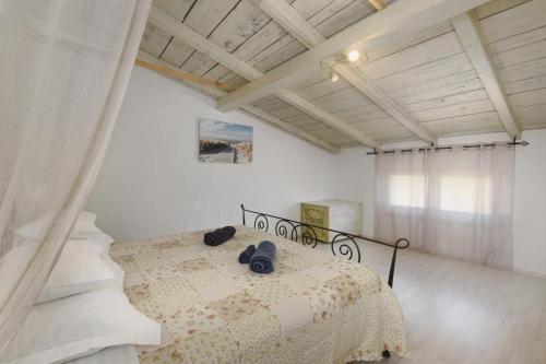 a bedroom with a bed with two shoes on it at Apartments on island Molat next to the sea - by TA Leut Agency in Brgulje
