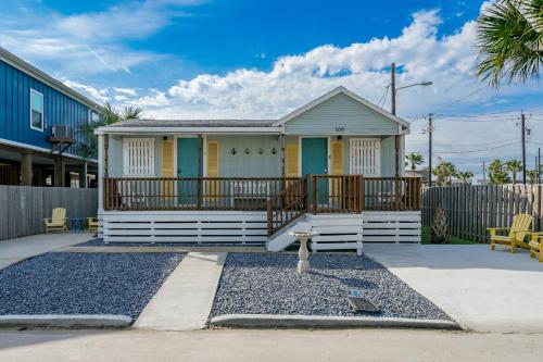 a small house with a porch and a fence at P Alister Trio in Port Aransas