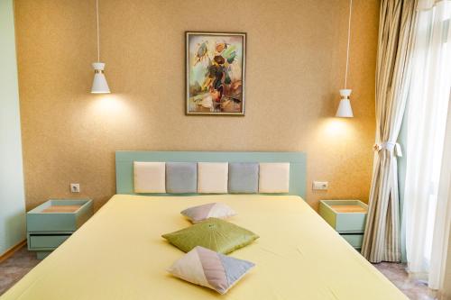 a bedroom with a bed with two pillows on it at Ravda Bay Guest House in Ravda