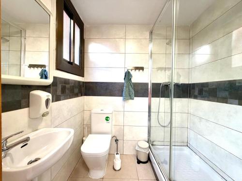 a bathroom with a toilet and a sink and a shower at close to beach and 15 mints to la rambla by tren in Sant Adria de Besos