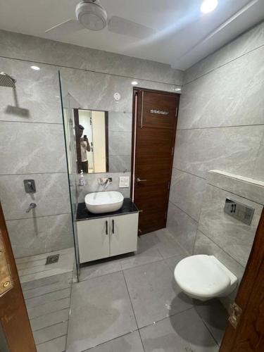 a bathroom with a toilet and a sink and a mirror at Third Pole in Kathmandu