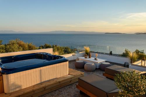 a hot tub on a patio with a view of the ocean at LemonTree Villa Rooftop Jacuzzi And Sea Views in Skopelos Town