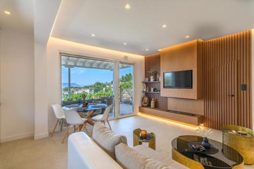 a living room with a couch and a table at LemonTree Villa Rooftop Jacuzzi And Sea Views in Skopelos Town