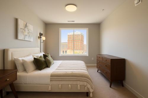 a bedroom with a large bed and a window at The Manor - Chevy Chase in Chevy Chase