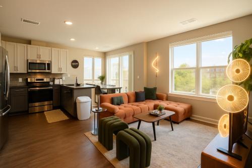 a living room with a couch and a kitchen at The Manor - Chevy Chase in Chevy Chase